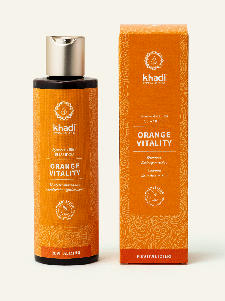 Botella de champú Orange Vitality con empaque